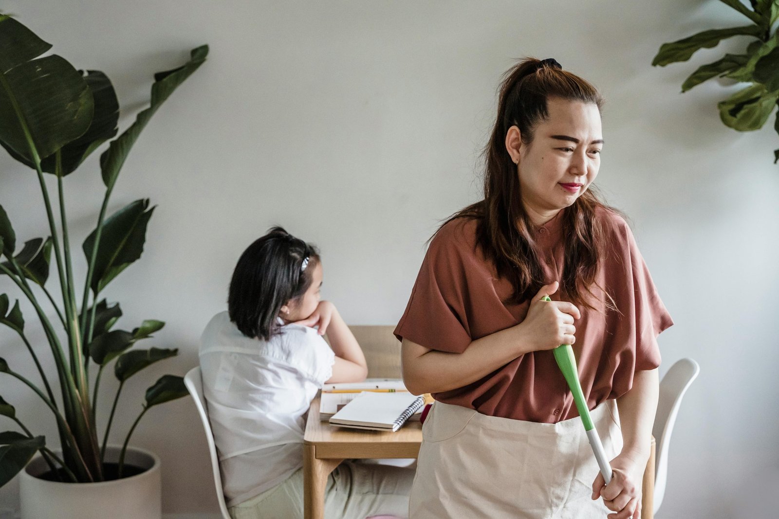 Professional cleaner sanitizing desks and classroom surfaces in a school environment